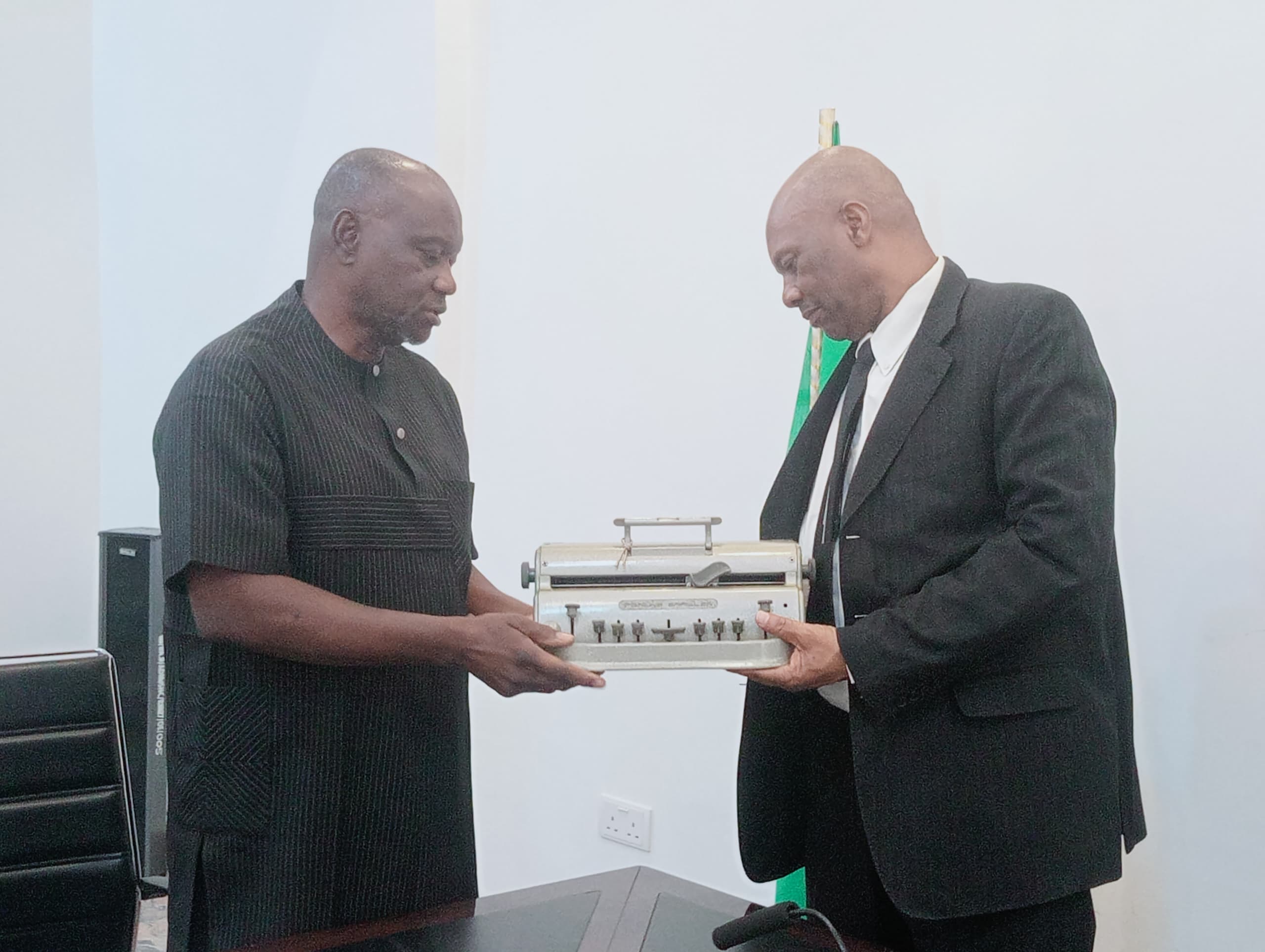 Mr. Andrew Gani-Ikilama, presenting two Perkins Braille Machines