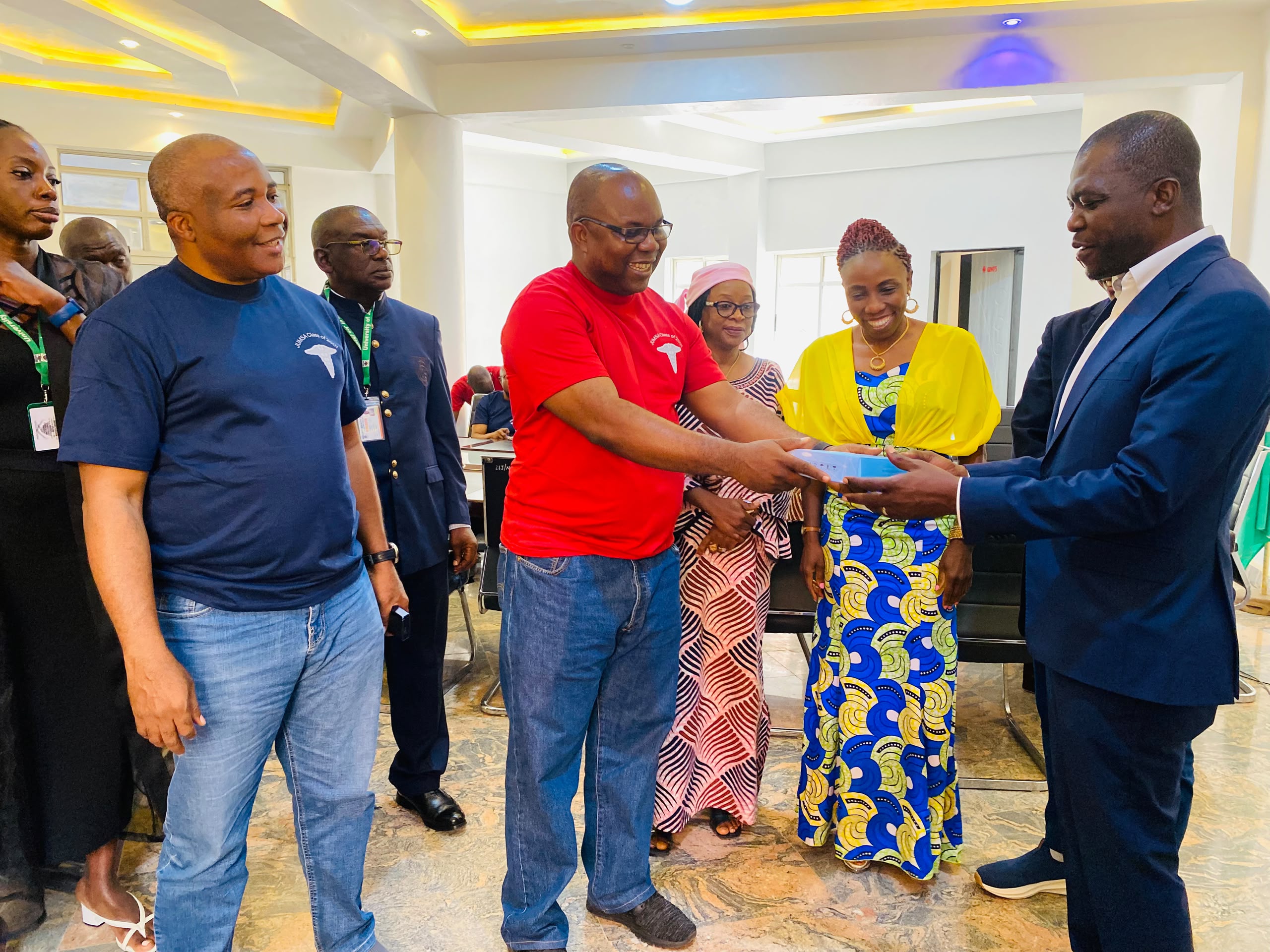 Chairman of the Class handing over an item to the Global President Unijos Alumni Asspciation Comrade Peter Gad Shamaki
