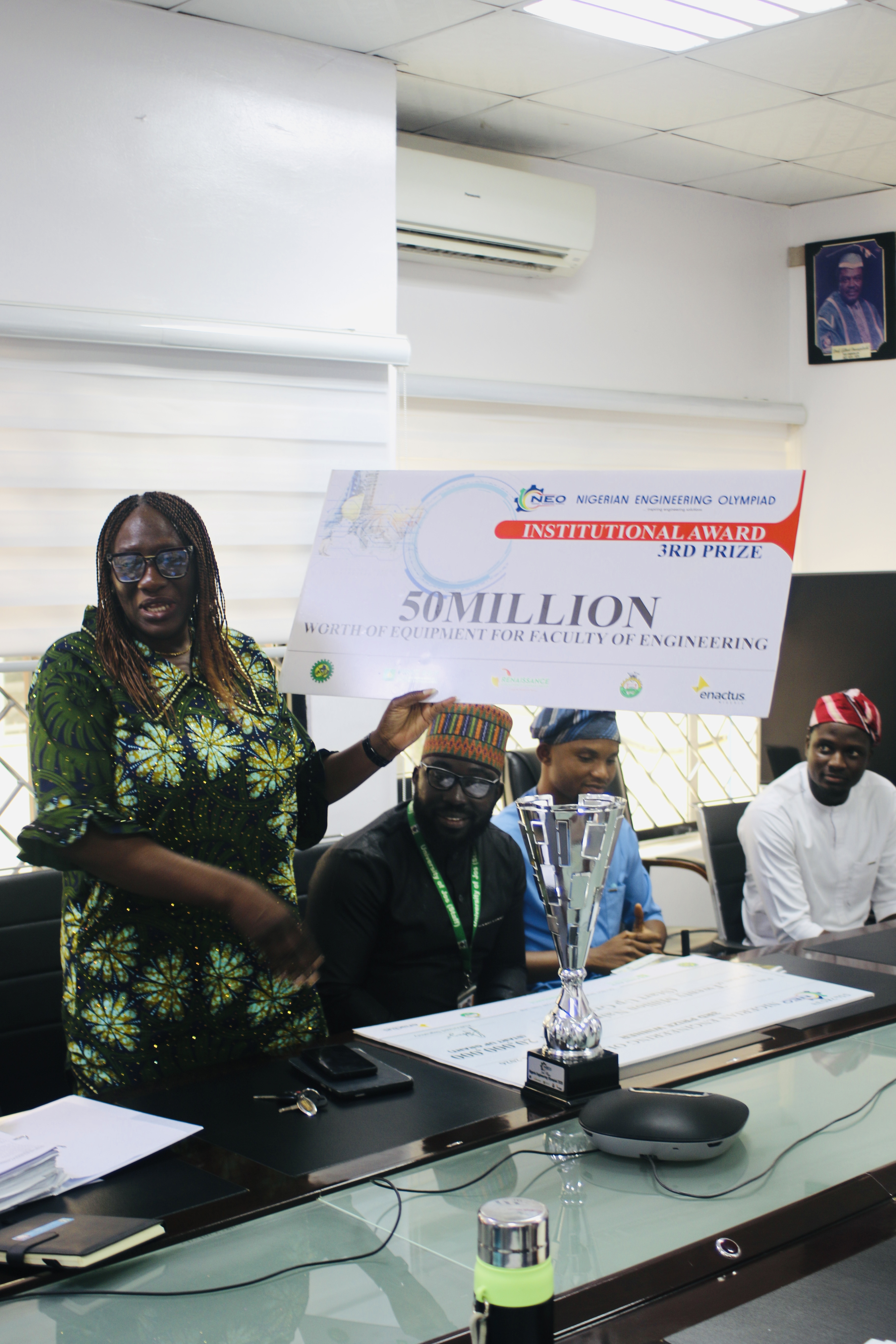 Dean faculty of Engineering Prof Rose E. Daffi dipslaying the dude cheque to Management.JPG