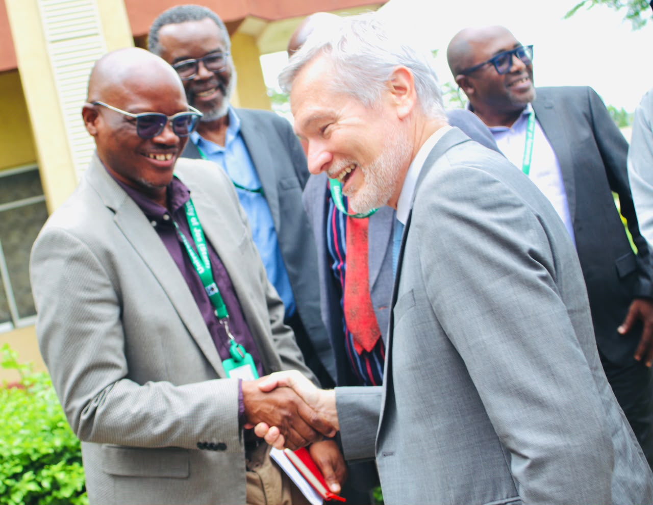 HE Ambassador Gautier Mignot in a warm handshake with Dean of Students Affairs  Professor Chris Piwuna