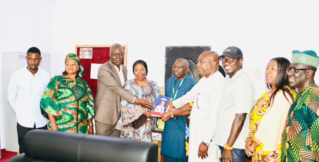 Symbolic handover of books.jpg