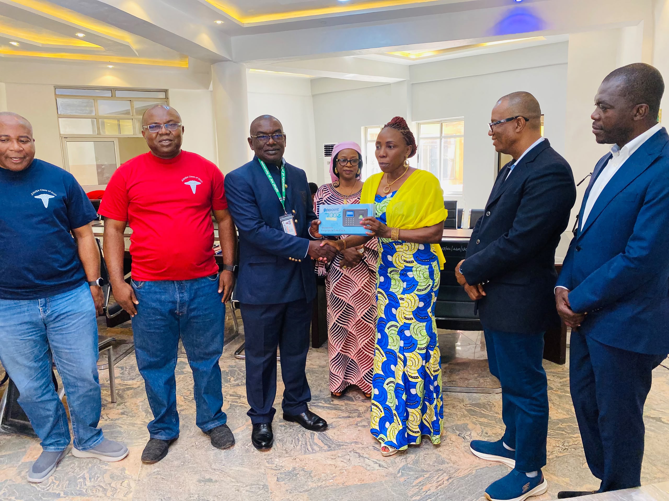 University Registrar receiving one of the donations from the 2001 Medical Class