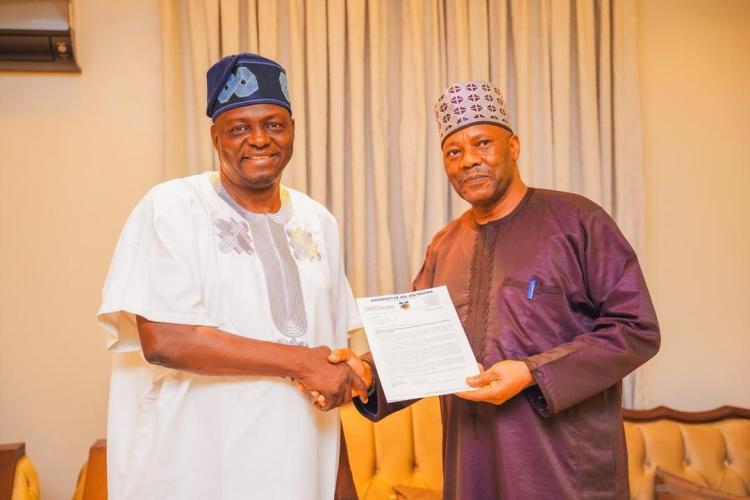 The APC National Chairman, Prof. Nentawe Yilwatda (left) receiving the letter of invitation from the Vice Chancellor, Prof. Tanko Ishaya during the visit.