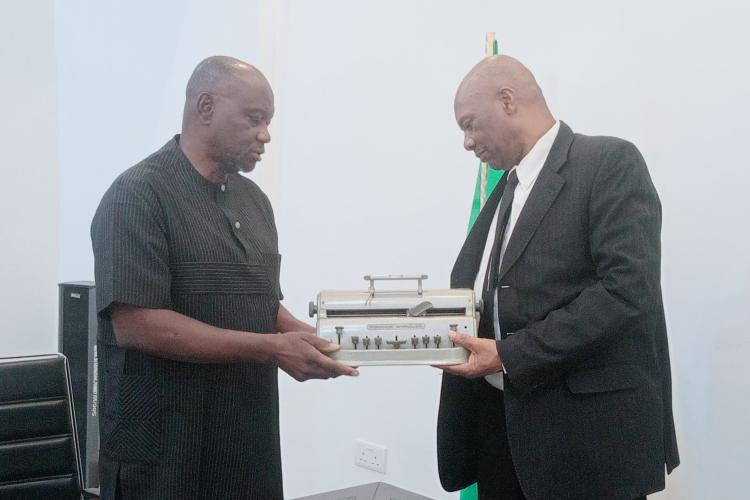 Mr. Andrew Gani-Ikilama, presenting two Perkins Braille Machines