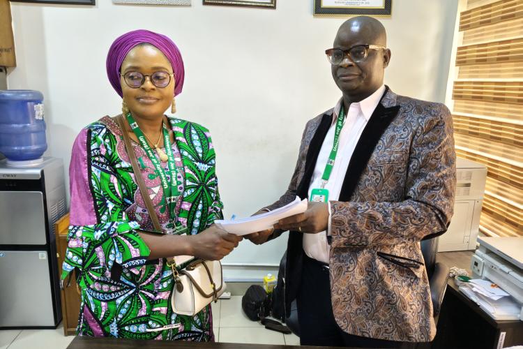Mr. Philip Umbugala handing over to Mrs Victoria Mankilik.jpg