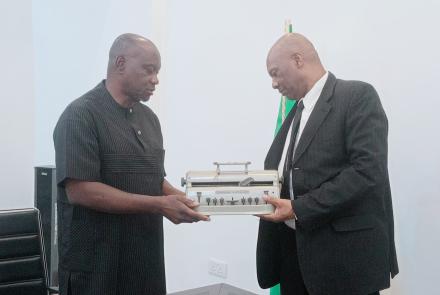 Mr. Andrew Gani-Ikilama, presenting two Perkins Braille Machines