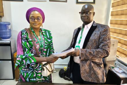 Mr. Philip Umbugala handing over to Mrs Victoria Mankilik.jpg