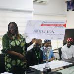 Dean faculty of Engineering Prof Rose E. Daffi dipslaying the dude cheque to Management.JPG