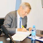 HE Ambassador Gautier Mignot signing the University Visitor;s book