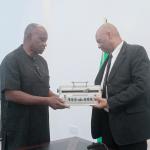 Mr. Andrew Gani-Ikilama, presenting two Perkins Braille Machines