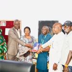 Symbolic handover of books.jpg