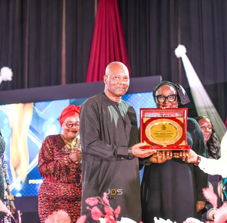 VC receiving the Award to the admiration of his dear wife, the Registrar, and Bursar..jpg